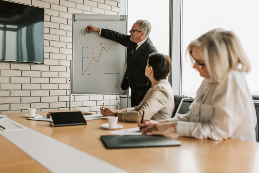 A group of professionals engaging in a business presentation in a stylish office setting.